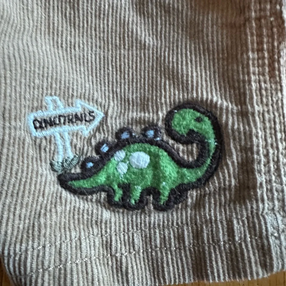 Oshkosh B’gosh Boy’s Size 12M  Tan Overalls w Dinosaurs Embroidery